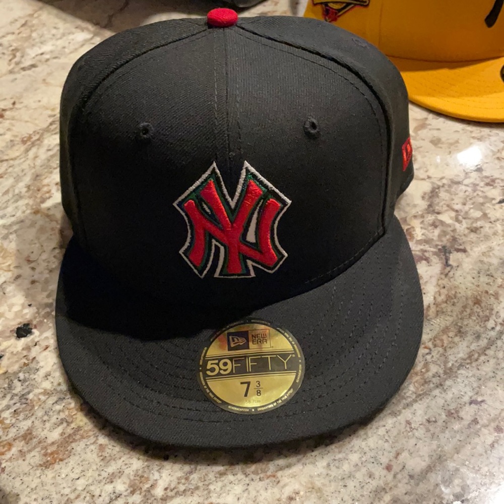 Black, Red, White, and Green hat size 7 3/8.